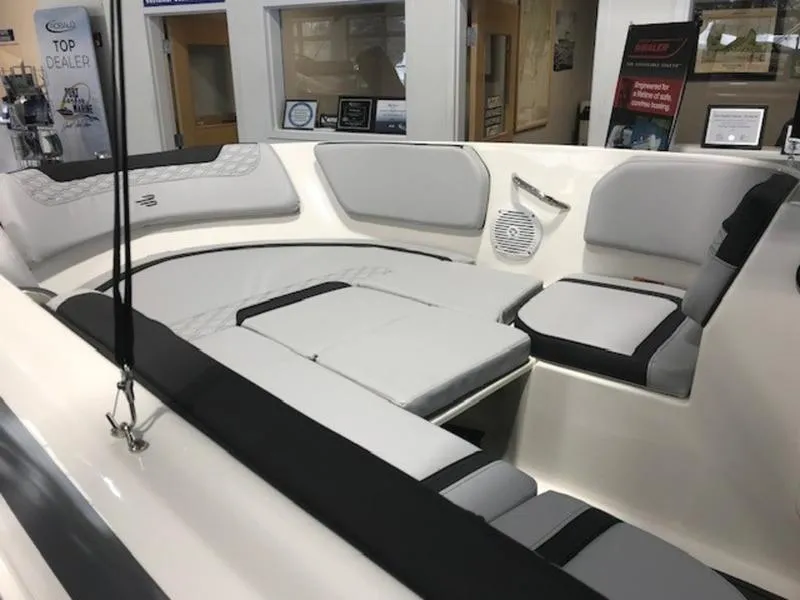 Slide: The Image of Interior view of 2025 Bayliner M15 boat with gray seating and modern design. - 14