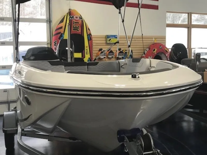 Slide: The Image of 2025 Bayliner M15 boat displayed indoors with water sports equipment in the background. - 3
