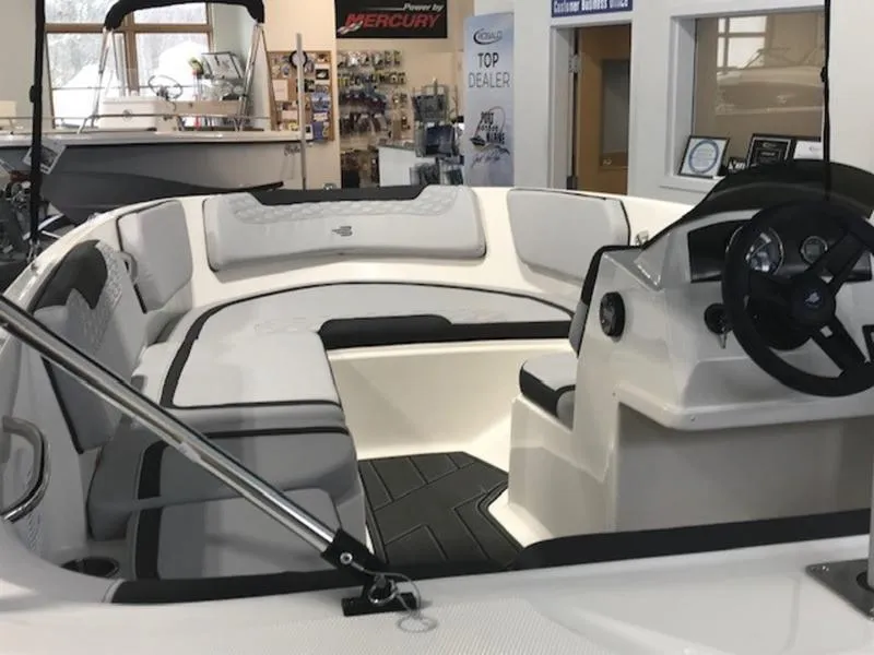 Slide: The Image of 2025 Bayliner M15 boat interior with modern seating and steering console. - 8