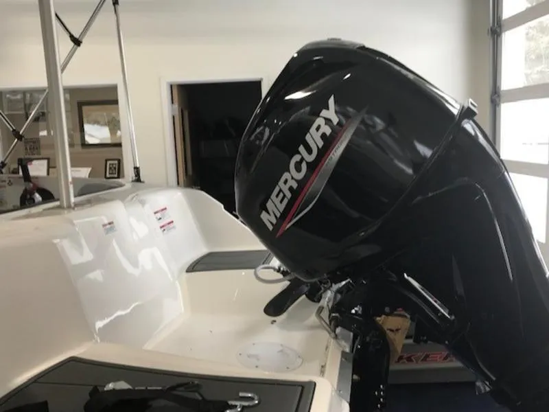 Slide: The Image of 2025 Bayliner M15 boat with Mercury outboard motor in showroom. - 9