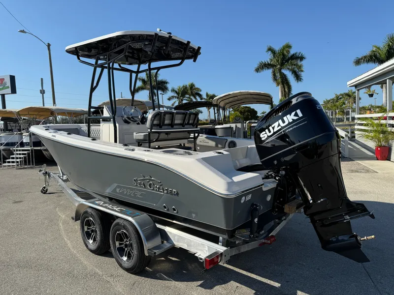 Slide: The Image of 2025 Sea Chaser 22 HFC boat with Suzuki engine on trailer, parked outdoors. - 10