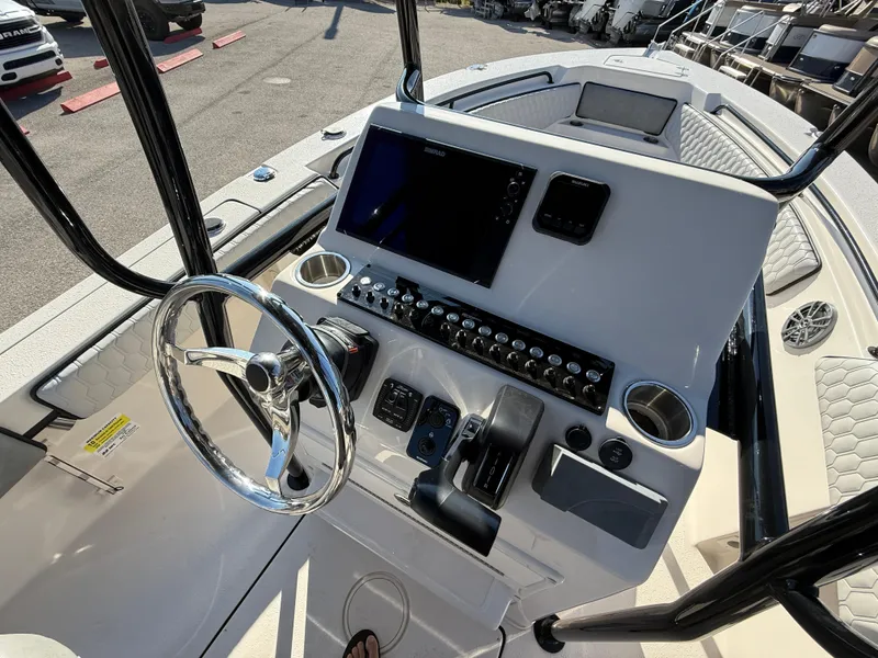 Slide: The Image of 2025 Sea Chaser 22 HFC boat dashboard with modern controls and steering wheel. - 15