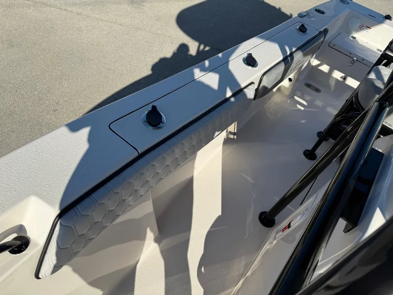 Slide: The Image of 2025 Sea Chaser 22 HFC boat interior with rod holders and storage compartments. - 21