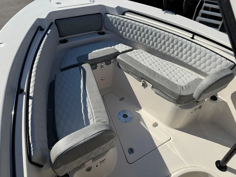 Slide: The Image of 2025 Sea Chaser 22 HFC boat interior with cushioned seating and storage compartments. - 26