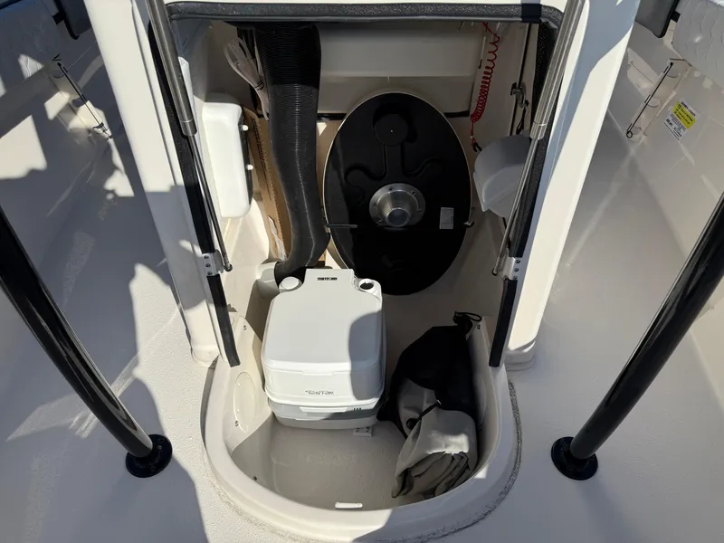 Slide: The Image of 2025 Sea Chaser 22 HFC boat interior with portable toilet and storage area. - 27