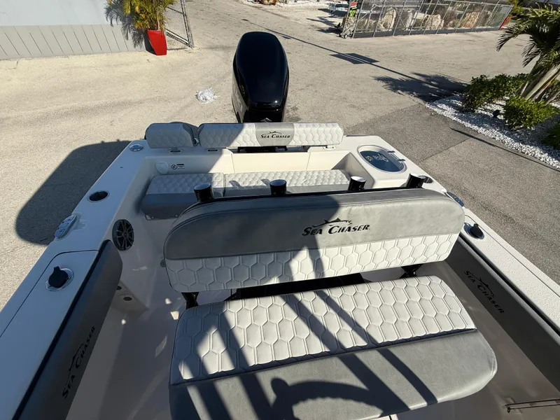 Slide: The Image of 2025 Sea Chaser 22 HFC boat interior with cushioned seating and outboard motor. - 32