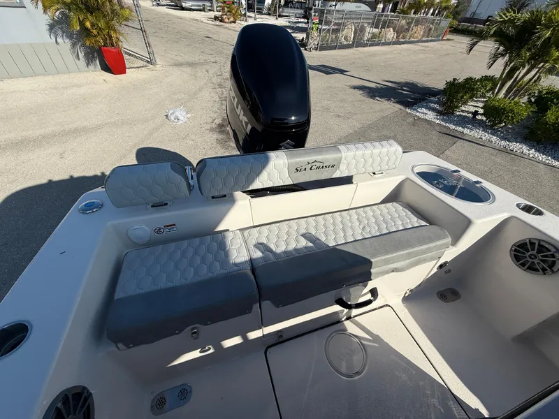 Slide: The Image of 2025 Sea Chaser 22 HFC boat interior with cushioned seating and motor view. - 33