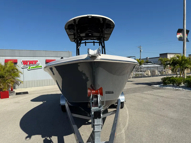 Slide: The Image of 2025 Sea Chaser 22 HFC boat on trailer, parked outdoors under clear blue sky. - 4