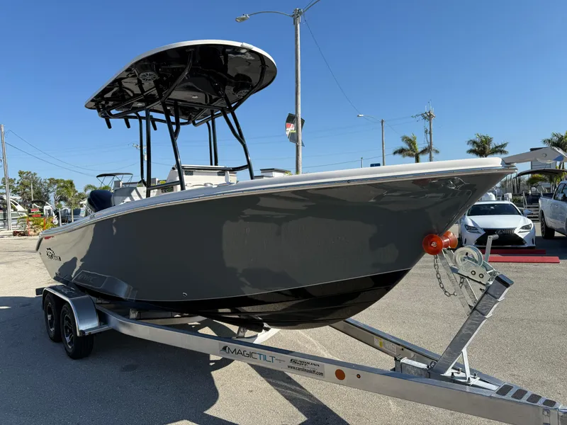 Slide: The Image of 2025 Sea Chaser 22 HFC boat on trailer, parked outdoors under clear sky. - 5