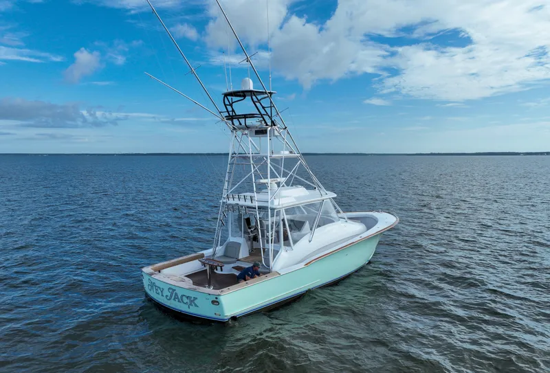 Slide: The Image of Custom Carolina 45 F&S 2008 boat on open water under a partly cloudy sky. - 13