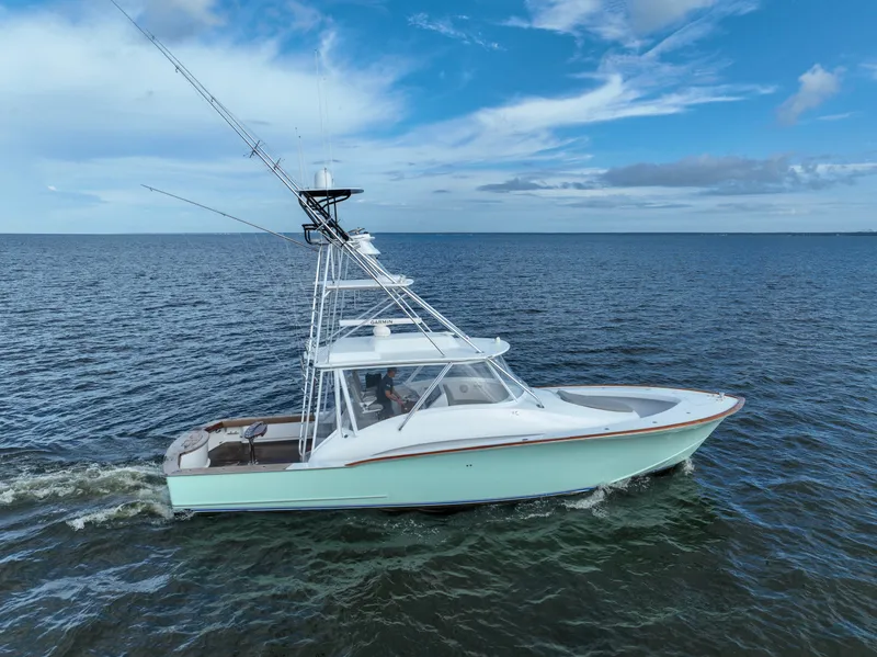 Slide: The Image of 2008 Custom Carolina 45 F&S boat cruising on open water under a clear blue sky. - 14