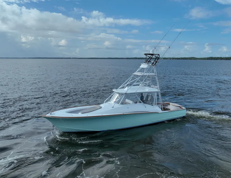 Slide: The Image of Custom Carolina 45 F&S 2008 boat cruising on open water under a cloudy sky. - 15