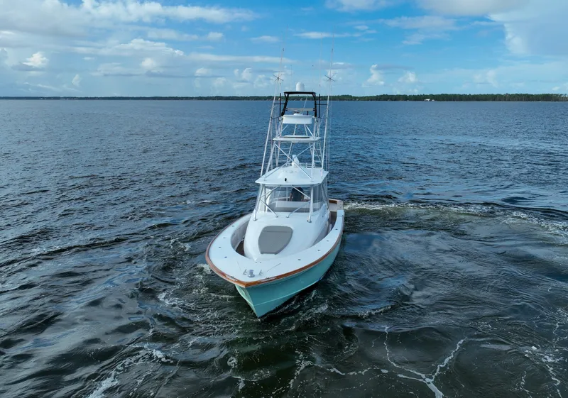 Slide: The Image of 2008 Custom Carolina 45 F&S boat cruising on open water under a blue sky. - 16