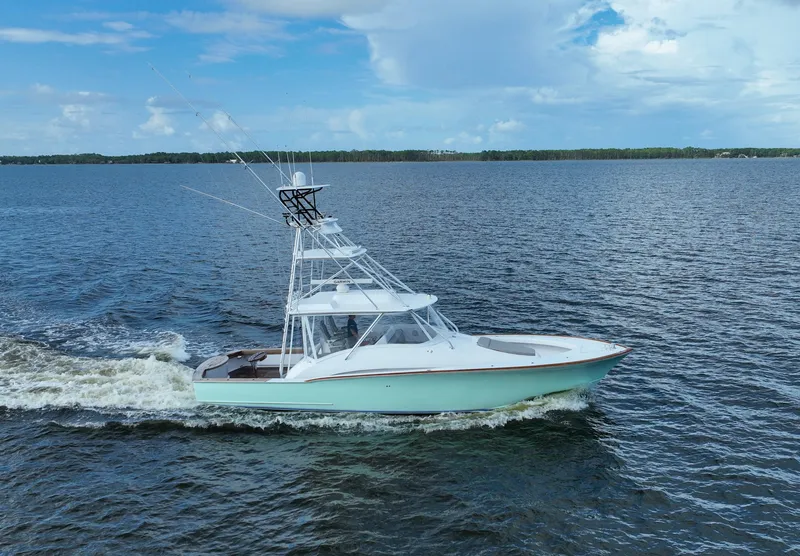 Slide: The Image of 2008 Custom Carolina 45 F&S boat cruising on open water under a blue sky. - 18