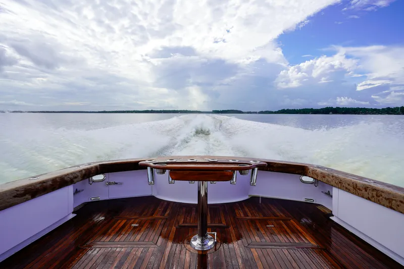 Slide: The Image of Custom Carolina 45 F&S 2008 boat cruising on open water, wooden deck, scenic sky. - 20
