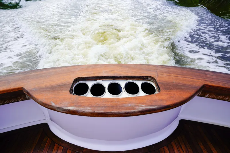 Slide: The Image of Custom Carolina 45 F&S 2008 boat stern with rod holders and wake view. - 22