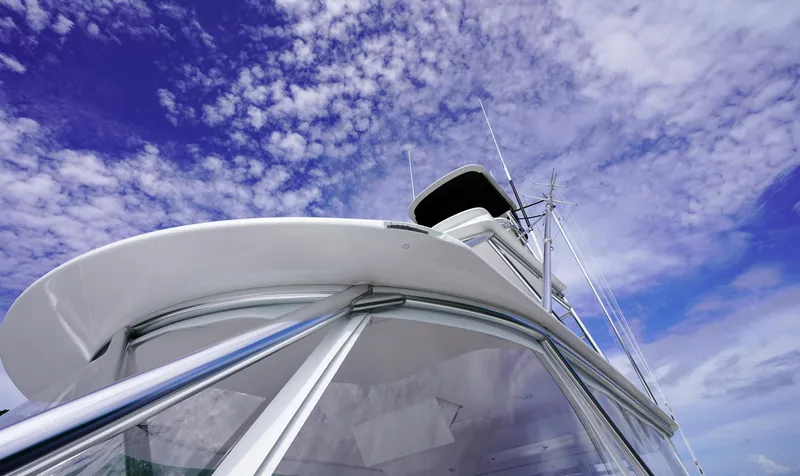 Slide: The Image of Custom Carolina 45 F&S 2008 boat against a vibrant blue sky with clouds. - 25