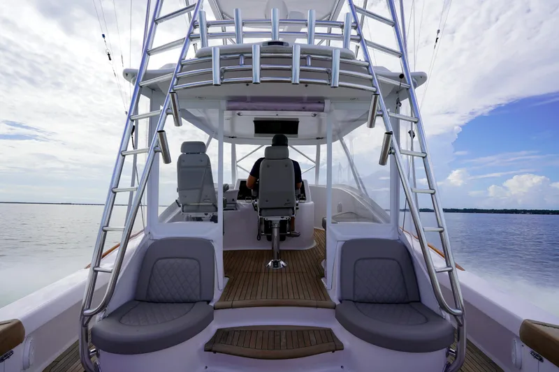 Slide: The Image of Custom Carolina 45 F&S 2008 boat interior with helm and seating, on calm waters. - 28