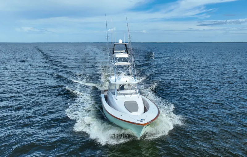 Slide: The Image of 2008 Custom Carolina 45 F&S boat cruising on open water under a clear sky. - 3