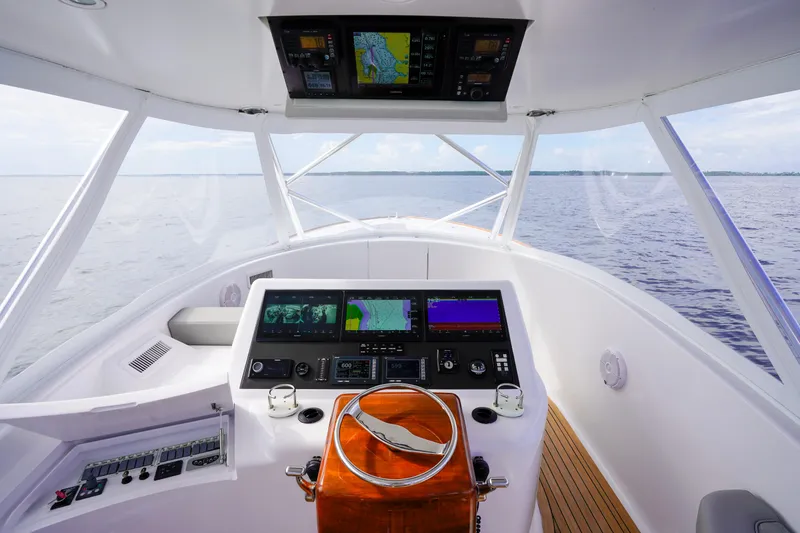 Slide: The Image of 2008 Custom Carolina 45 F&S yacht helm with navigation screens and steering wheel. - 33