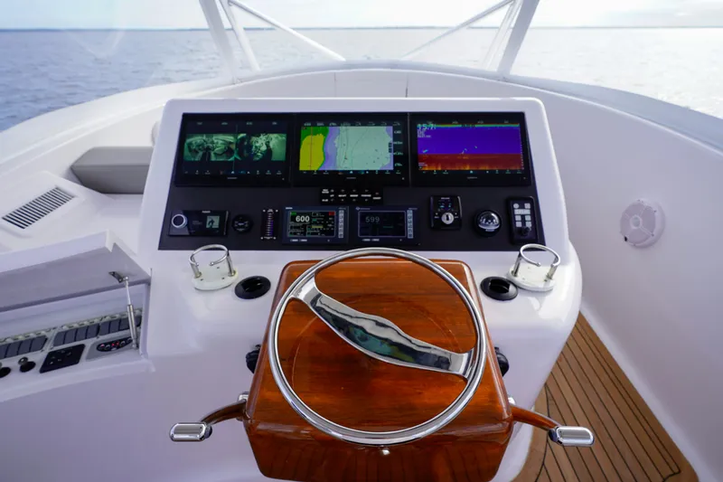 Slide: The Image of Custom Carolina 45 F&S 2008 yacht helm with advanced navigation displays and wooden steering wheel. - 34