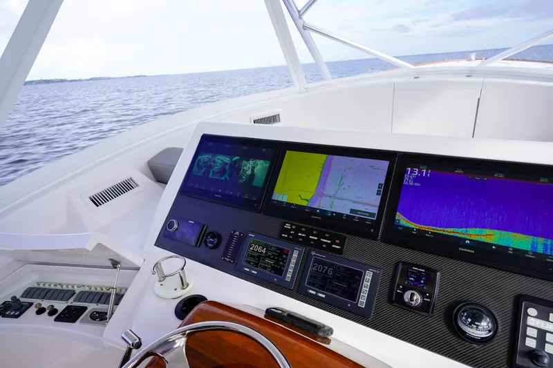 Slide: The Image of Helm of 2008 Custom Carolina 45 F&S with advanced navigation displays on open water. - 35