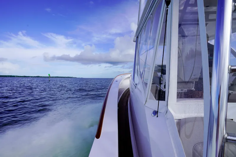Slide: The Image of Custom Carolina 45 F&S 2008 boat cruising on open water under a clear blue sky. - 39