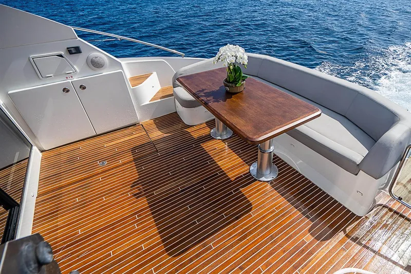 Slide: The Image of 2017 Beneteau Gran Turismo yacht deck with seating, table, and ocean view. - 12