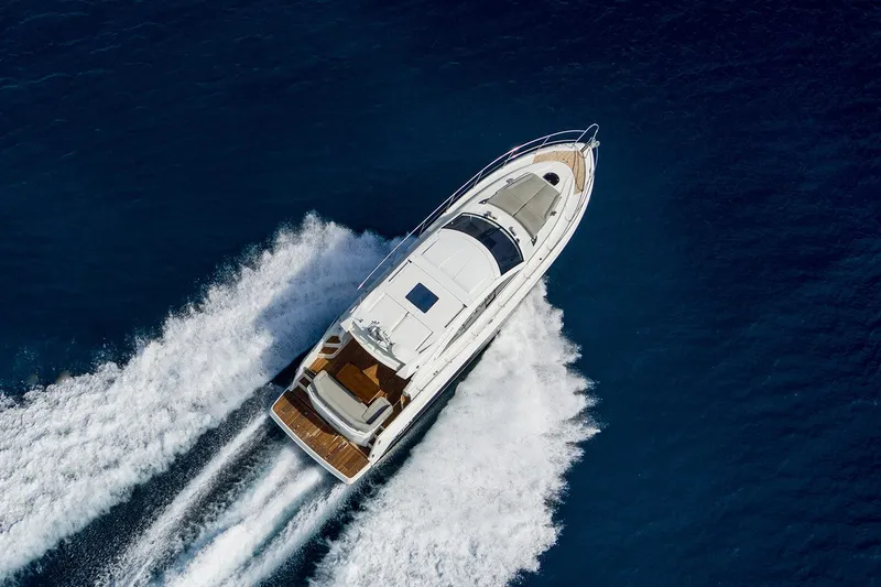 Slide: The Image of 2017 Beneteau GRAN TURISMO yacht cruising on open water, aerial view. - 2