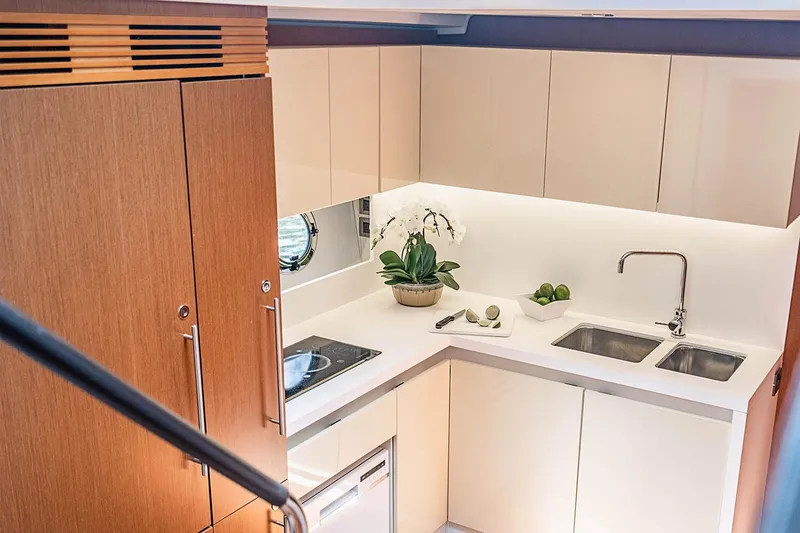 Slide: The Image of Modern kitchen interior on 2017 Beneteau GRAN TURISMO yacht, featuring sleek cabinetry and dual sinks. - 29