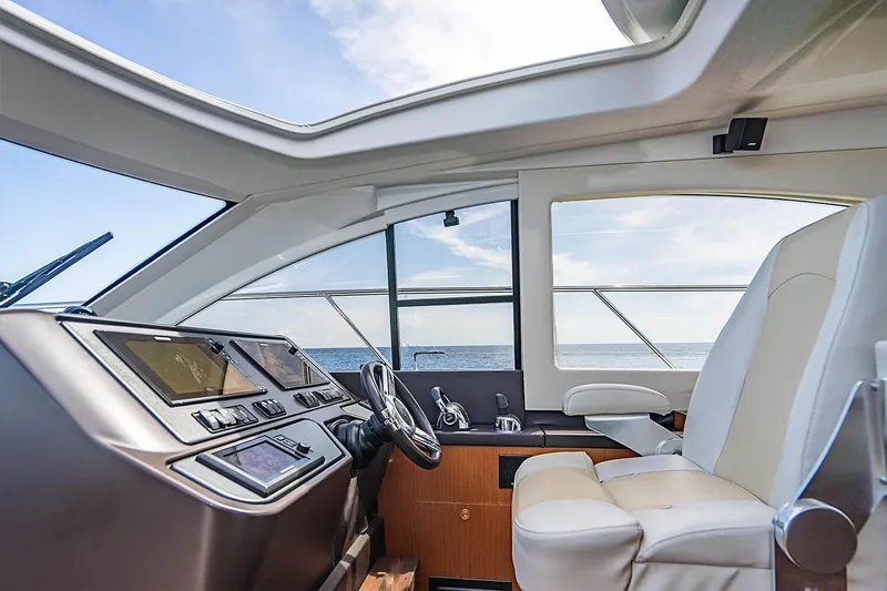 Slide: The Image of Interior of 2017 Beneteau Gran Turismo yacht, featuring modern helm and luxurious seating. - 32