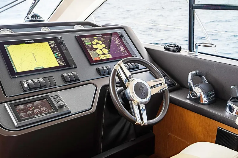 Slide: The Image of Helm of 2017 Beneteau Gran Turismo with modern navigation displays and controls. - 33