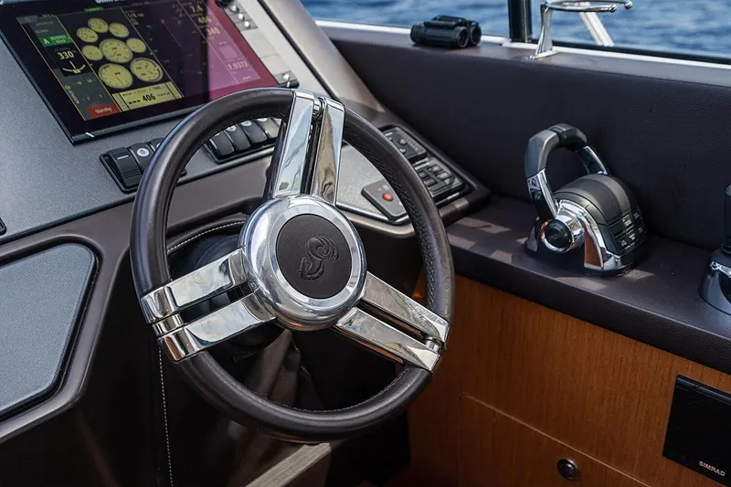 Slide: The Image of Steering wheel and controls of a 2017 Beneteau Gran Turismo yacht. - 34