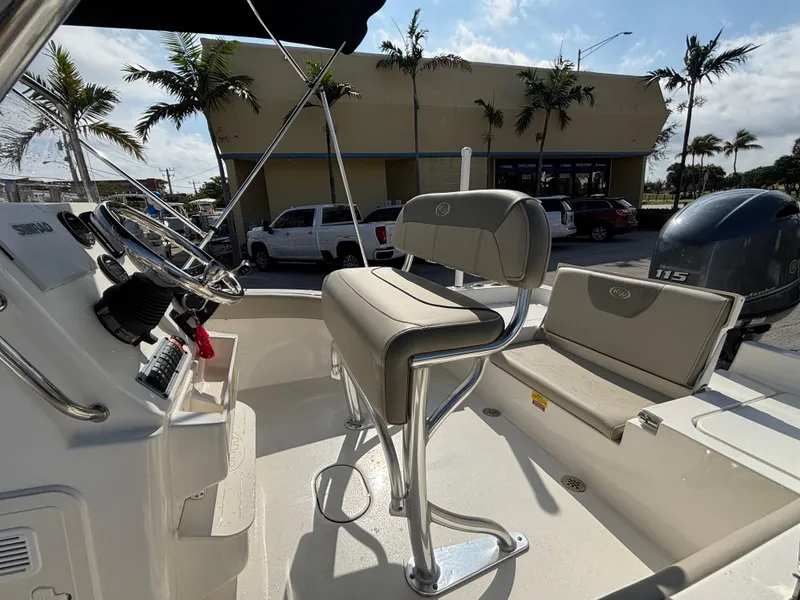 Slide: The Image of 2024 Key West 179 FS boat interior with steering console and seating. - 13