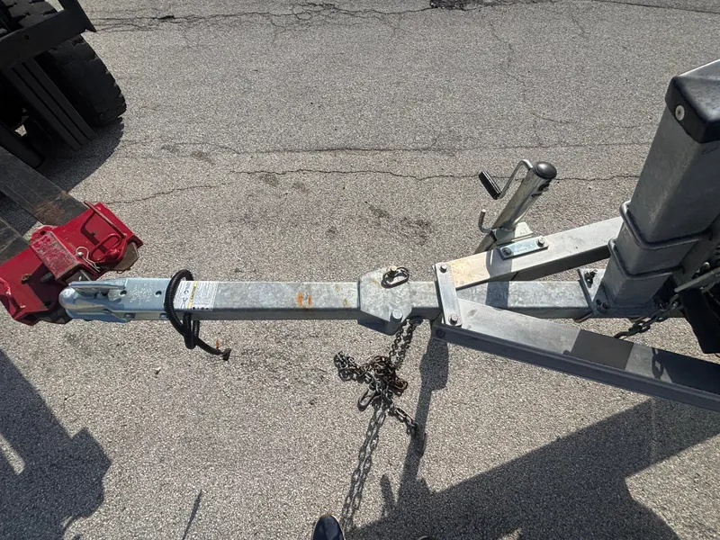 Slide: The Image of Trailer hitch of a 2024 Key West 179 FS boat on asphalt surface. - 14