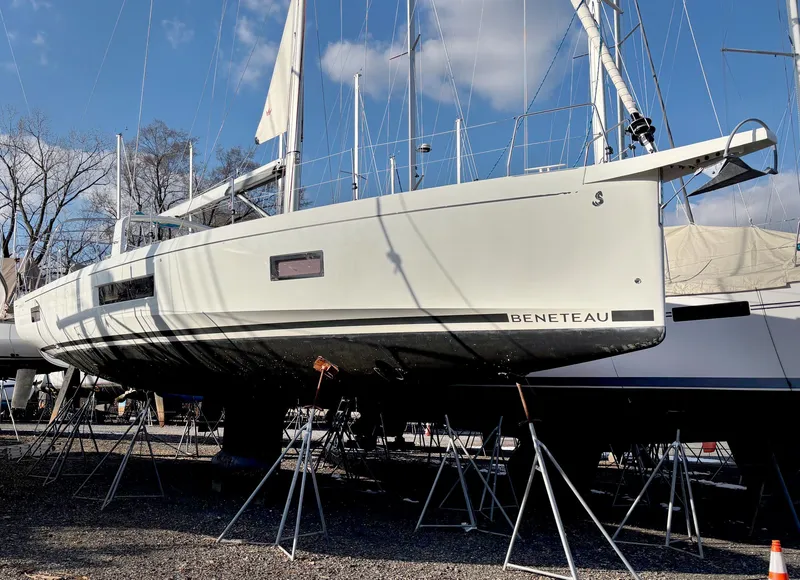 Slide: The Image of 2022 Beneteau Oceanis 51.1 sailboat on stands, displayed outdoors under a clear sky. - 13