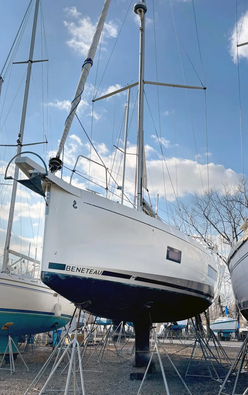 Slide: The Image of Beneteau Oceanis 51.1 sailboat, 2022 model, displayed on stands under a clear sky. - 14