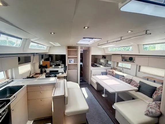 Slide: The Image of Luxurious interior of 2022 Beneteau Oceanis 51.1 yacht with modern furnishings and ample natural light. - 18