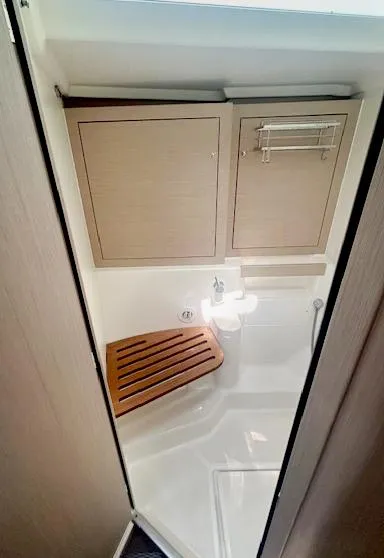 Slide: The Image of Bathroom interior of 2022 Beneteau Oceanis 51.1 yacht, featuring wooden seat and modern fixtures. - 22