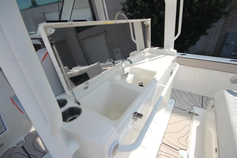 Slide: The Image of 2026 Zodiac X10CC boat interior with storage compartment, speaker, and quilted seating. - 15