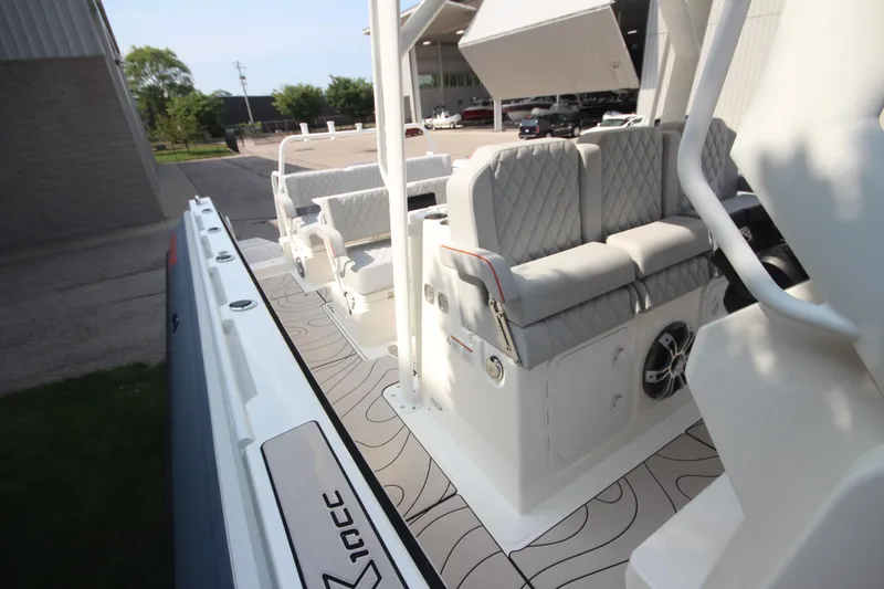 Slide: The Image of 2026 Zodiac X10CC boat with open storage compartments, viewed from above, near a parked vehicle. - 19