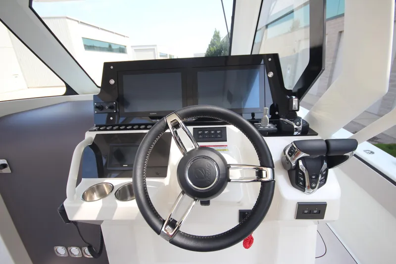 Slide: The Image of 2026 Zodiac X10CC boat with Twin Yamaha F350XSA2 engines and joystick, docked near buildings. - 21