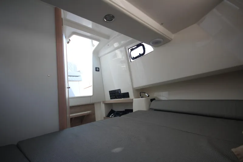 Slide: The Image of 2026 Zodiac X10CC boat interior with covered seating and rod holders. - 27