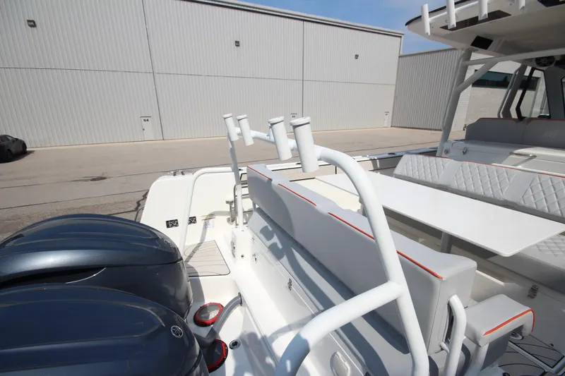 Slide: The Image of 2026 Zodiac X10CC boat interior with beige seating and table, featuring cup holders and speakers. - 9