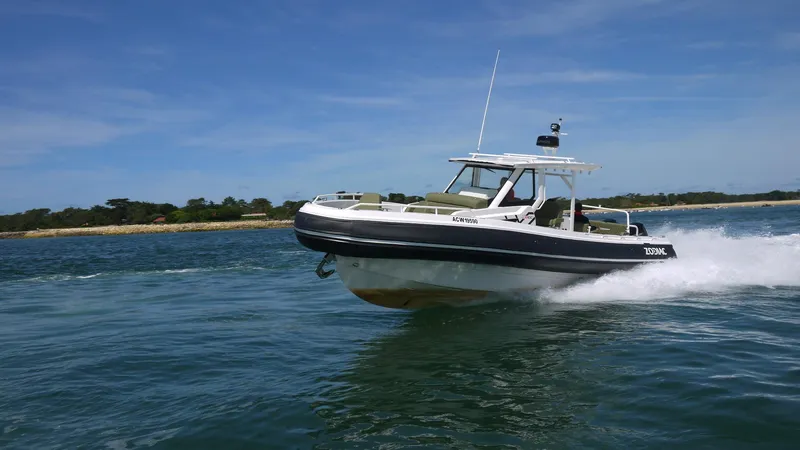 Slide: The Image of 2025 Zodiac X10CC boat with twin Yamaha 450 engines cruising on water. - 1