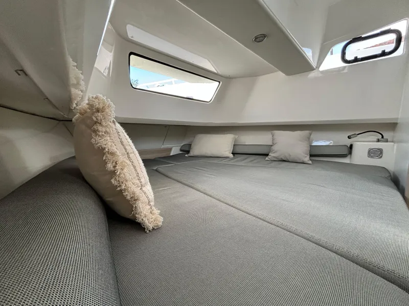 Slide: The Image of Luxurious cabin interior of 2025 Zodiac X10CC boat with plush bedding and modern design. - 11