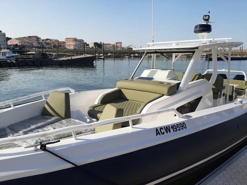 Slide: The Image of 2025 Zodiac X10CC boat with twin Yamaha 450 engines, docked in a marina. - 13