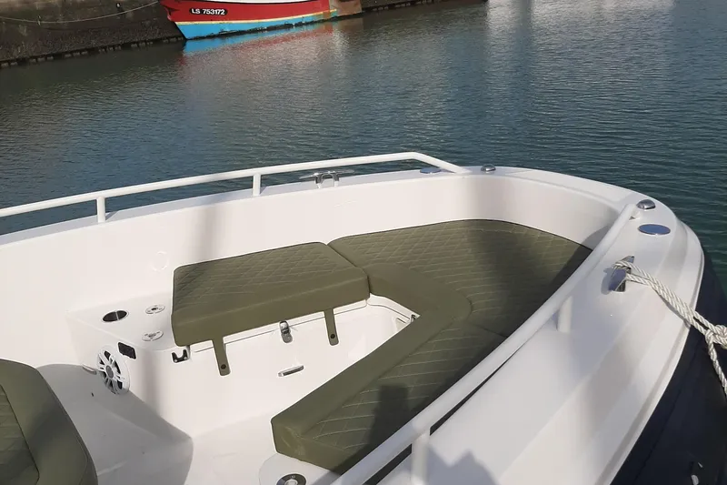 Slide: The Image of 2025 Zodiac X10CC boat with seating area, docked in calm waters. - 22