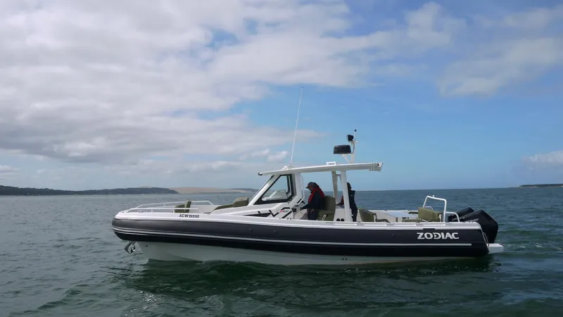 Slide: The Image of 2025 Zodiac X10CC boat with twin Yamaha 450 engines on open water. - 3