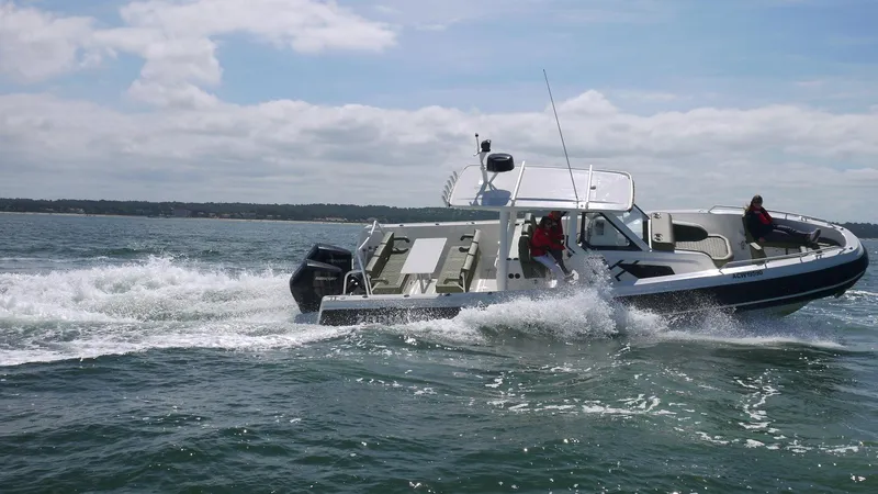 Slide: The Image of 2025 Zodiac X10CC boat with twin Yamaha 450 engines cruising on water. - 5